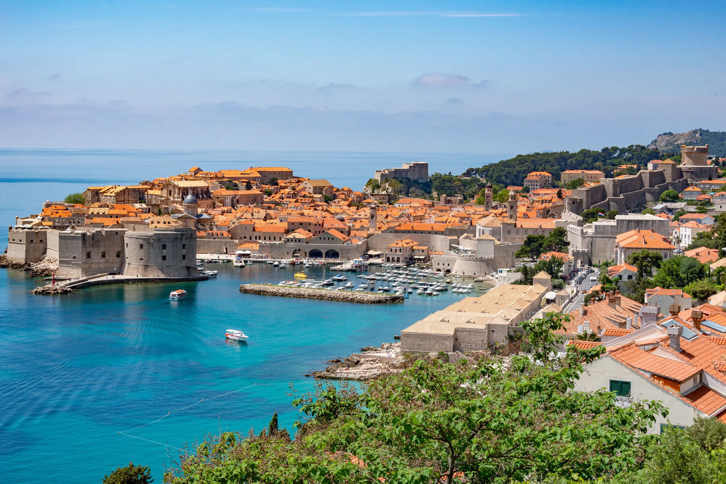 Dubrovnik’s old harbour and Old Town walls above the sea