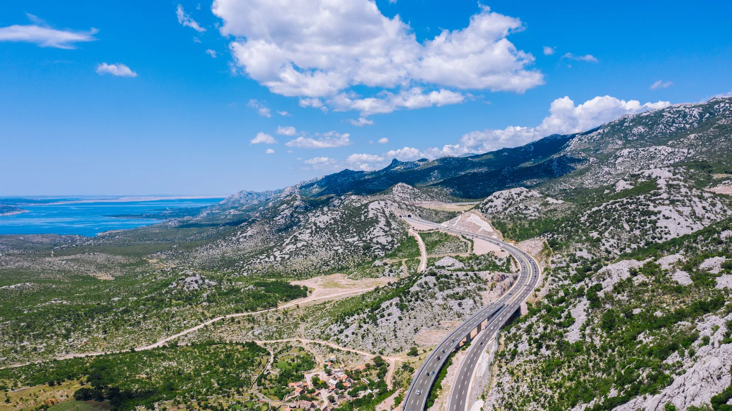 Motorway winding through rocky hills above the Croatian coast